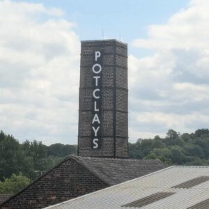 Potclays sigh attached to a brick mill chimney